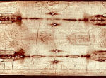 Wooden coffin lid with several carved, full-length human figures arranged along its length.