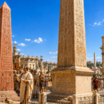 Ancient Roman forum scene with tall inscribed obelisks, a grand arch with a four-horse statue, and people in togas wandering the square.