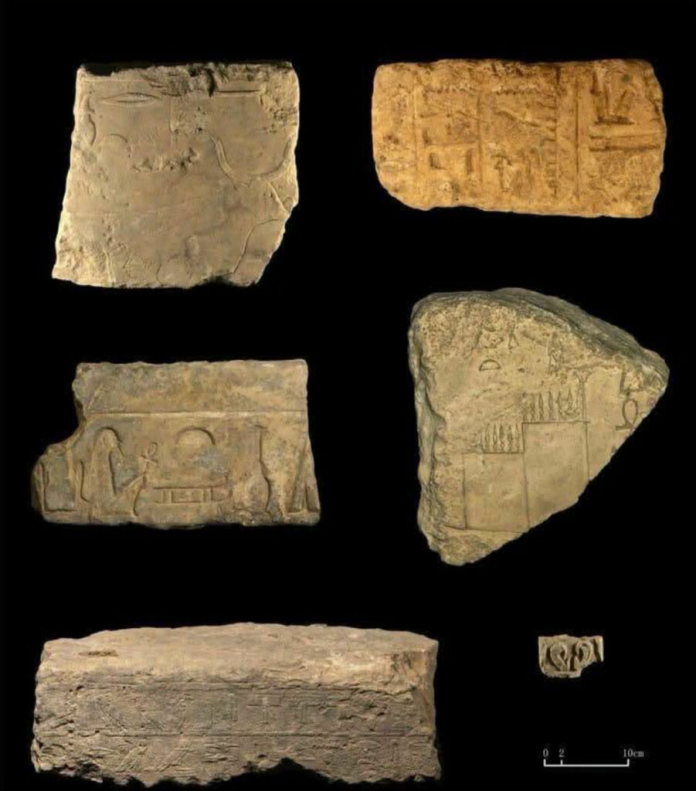 Egypt_Memphis Six ancient clay tablets with hieroglyphic inscriptions laid out on a black background.